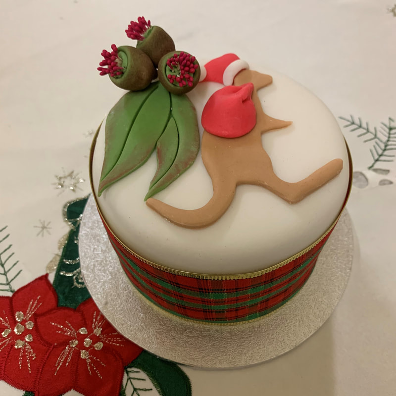 decorated Christmas cake with kangaroo with a santa hat and red sack