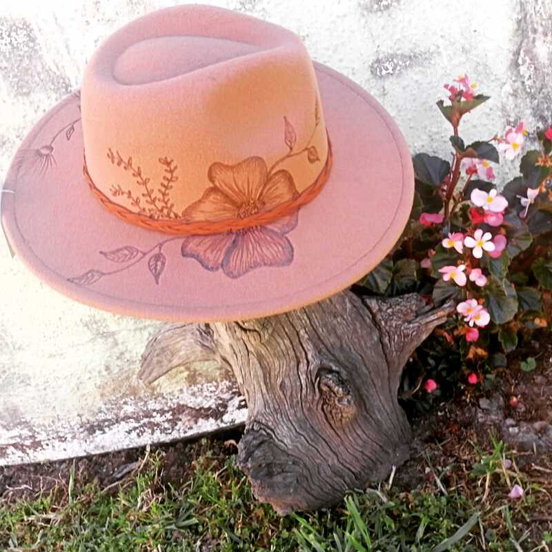 felt hat which has a floral design burnt into the felt, all done by hand