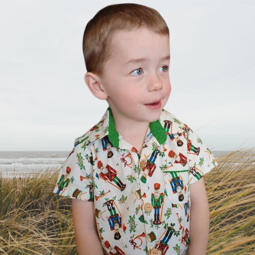 young boy wearing a handsewn shirt featuring Christmas soldiers