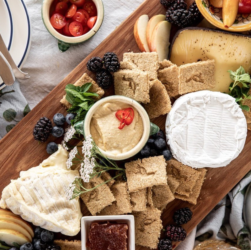 cheese platter with oatcakes, crackers and fruit