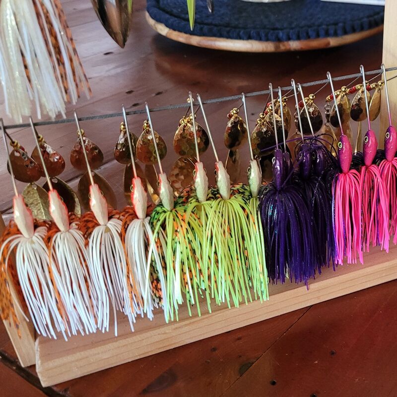 handmade spinner lures hanging on a rack