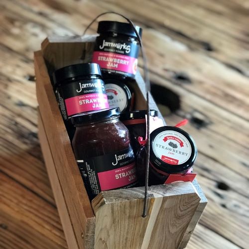 jars of strawberry jam in a wooden box