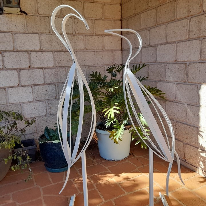 two stylised garden art metal bird sculptures