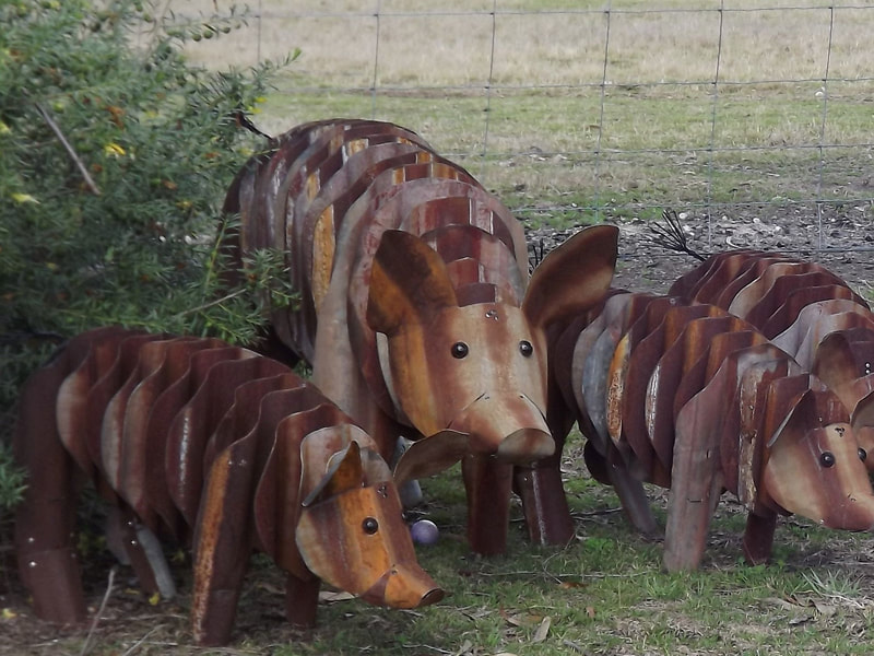 corrugated tin pig sculptures for the garden
