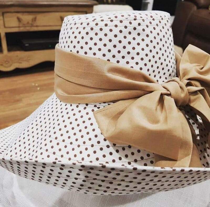 handcrafted hat in spot fabric and caramel band and bow