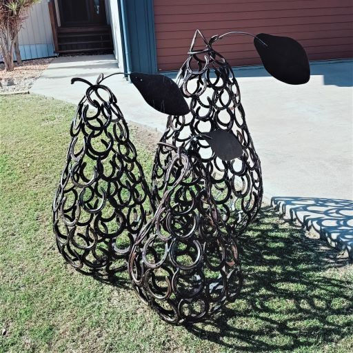 three welded garden art pear sculture made from old horse shoes